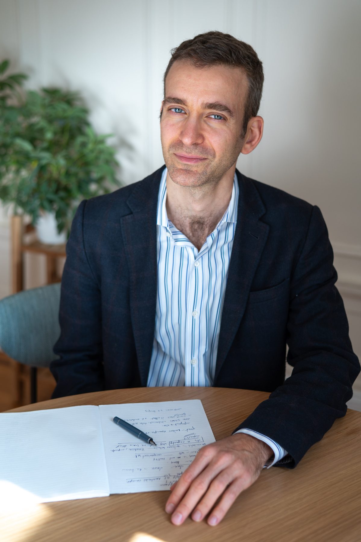 Dr. Daniel Laor at his desk with an open notebook
